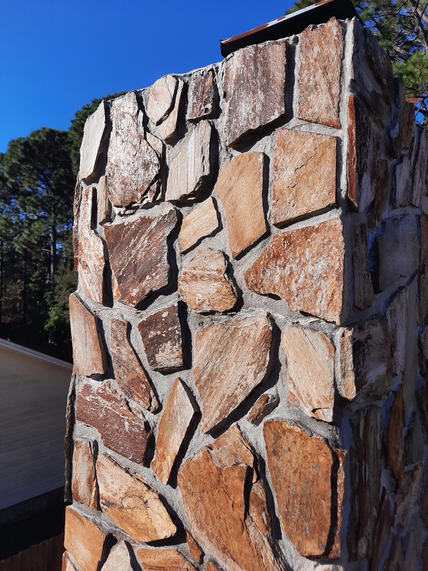 Stone masonry chimney